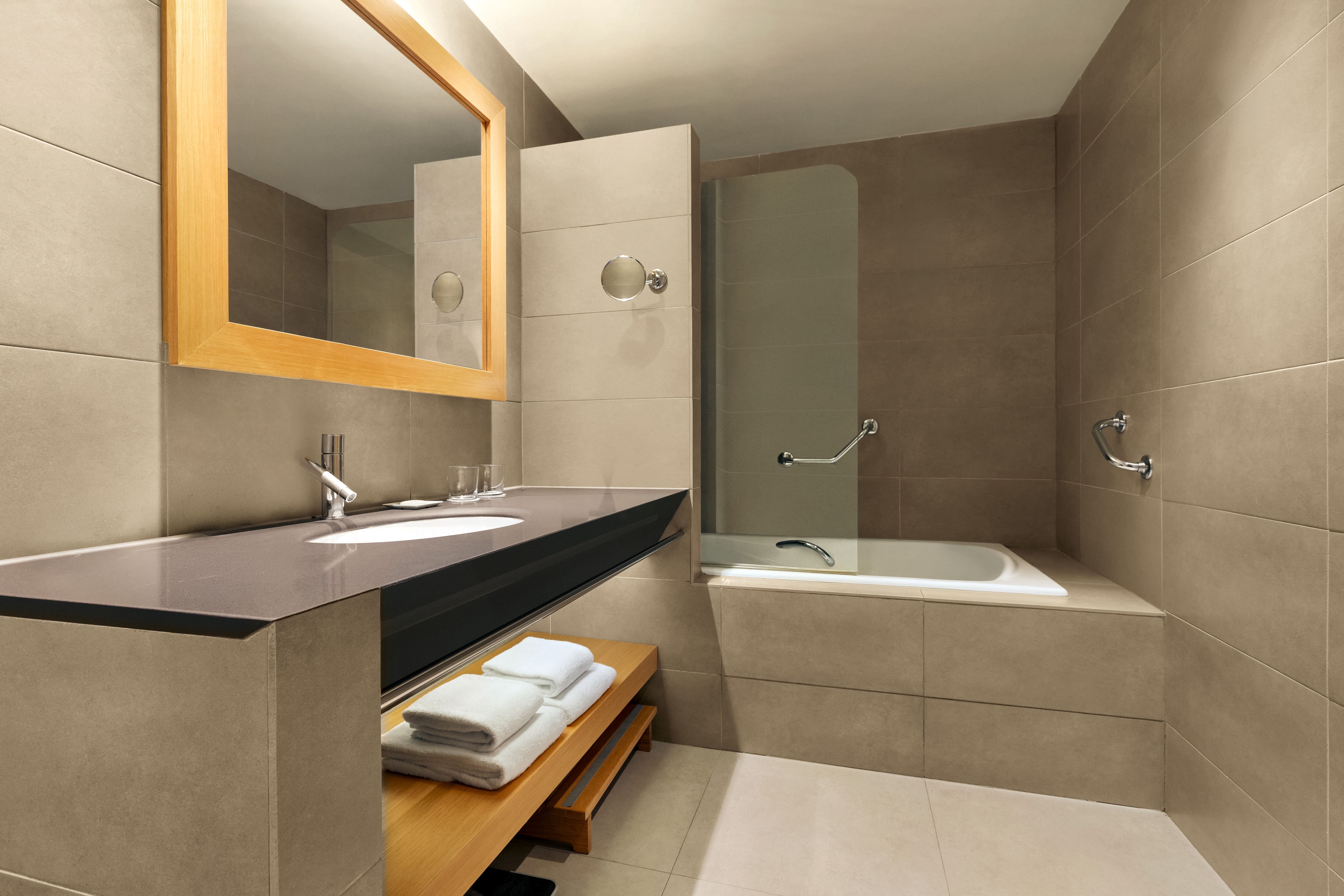 a bathroom with a bathtub and a mirror
