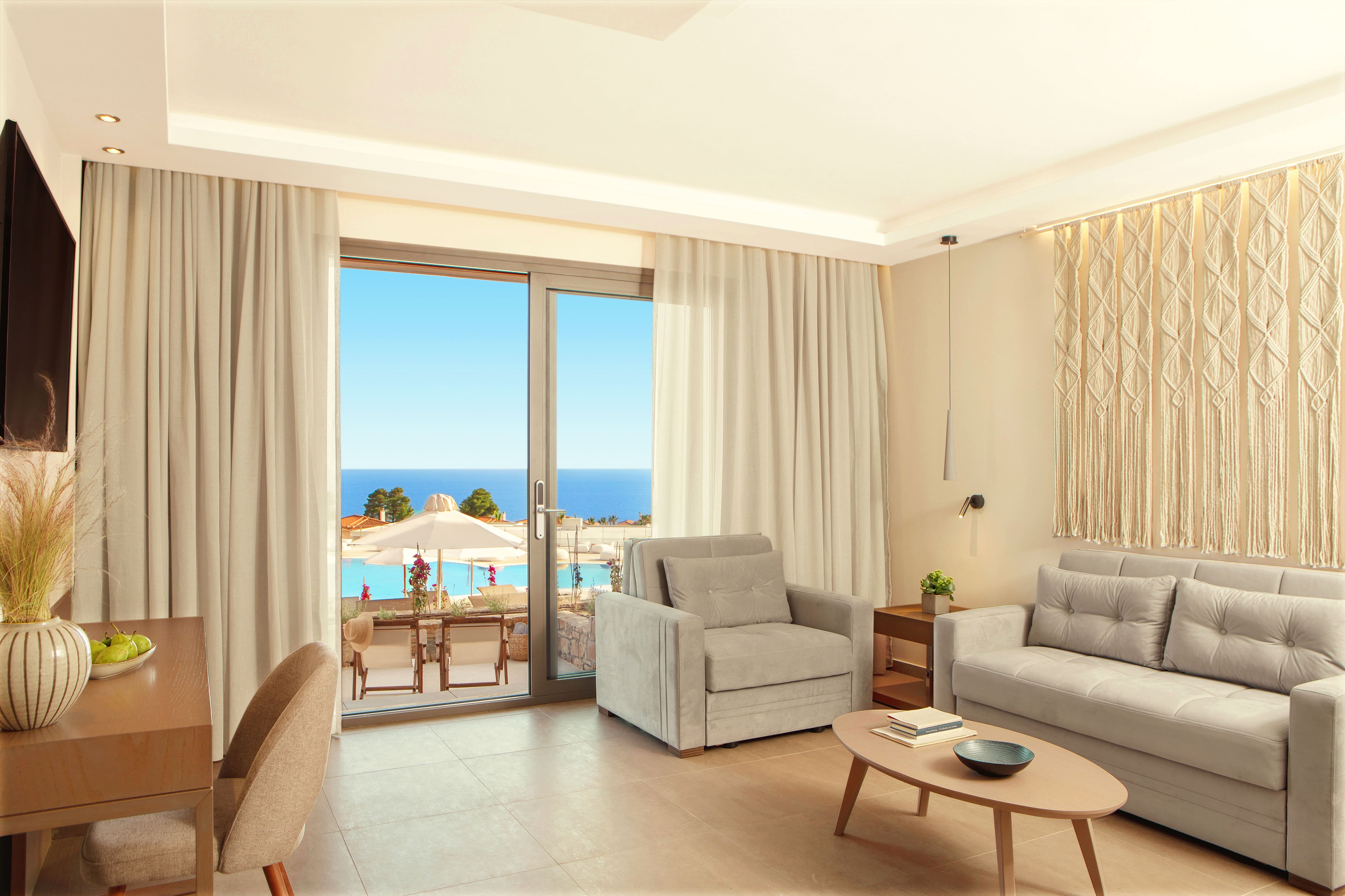 a living room with a view of the ocean