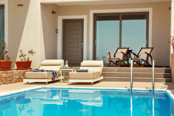 a pool with chairs and a deck chair