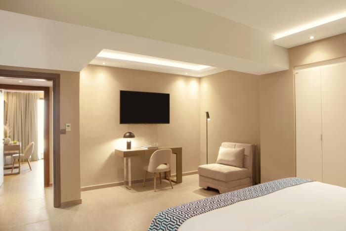 a bedroom with a bed and a chair