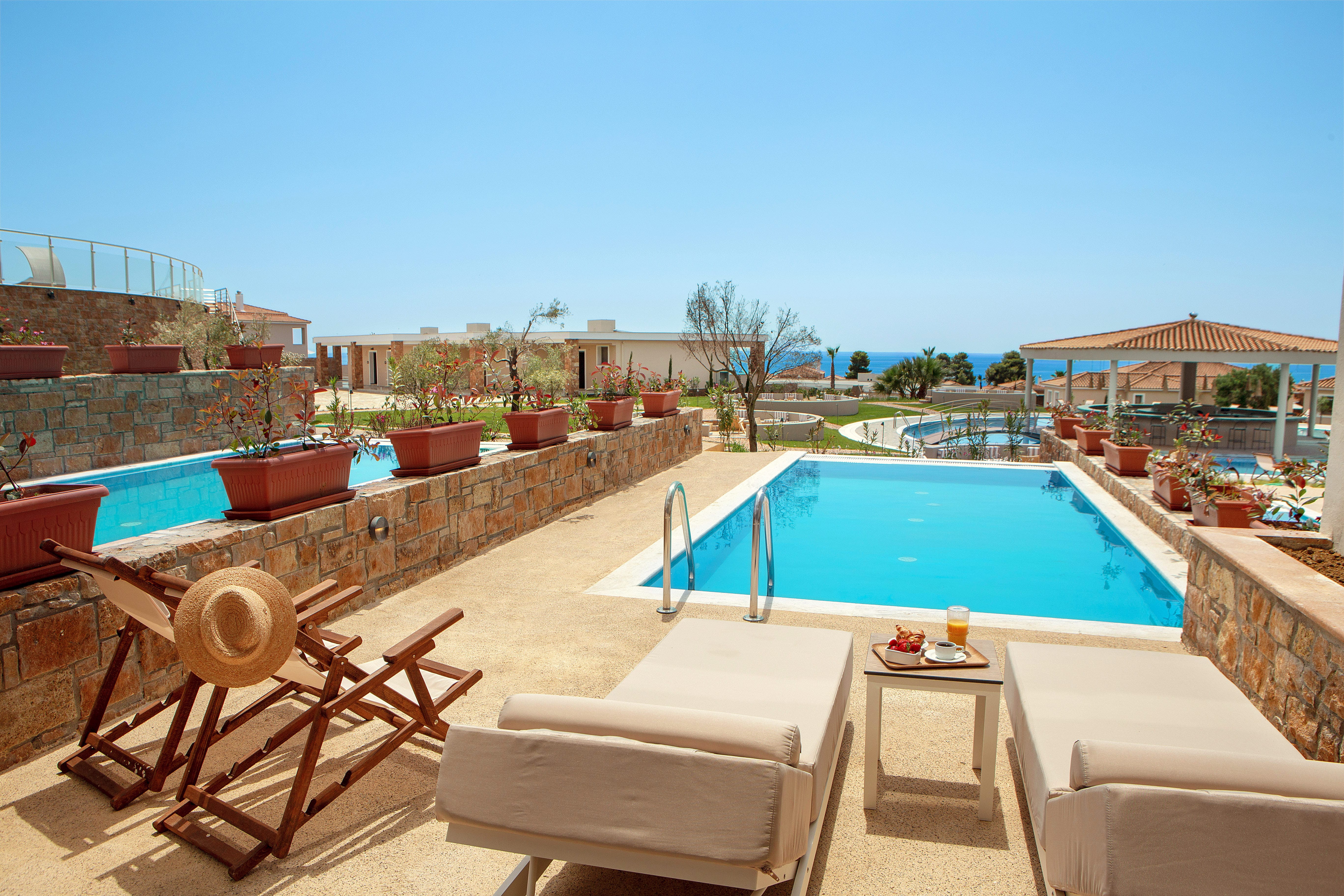 a pool with chairs and a table