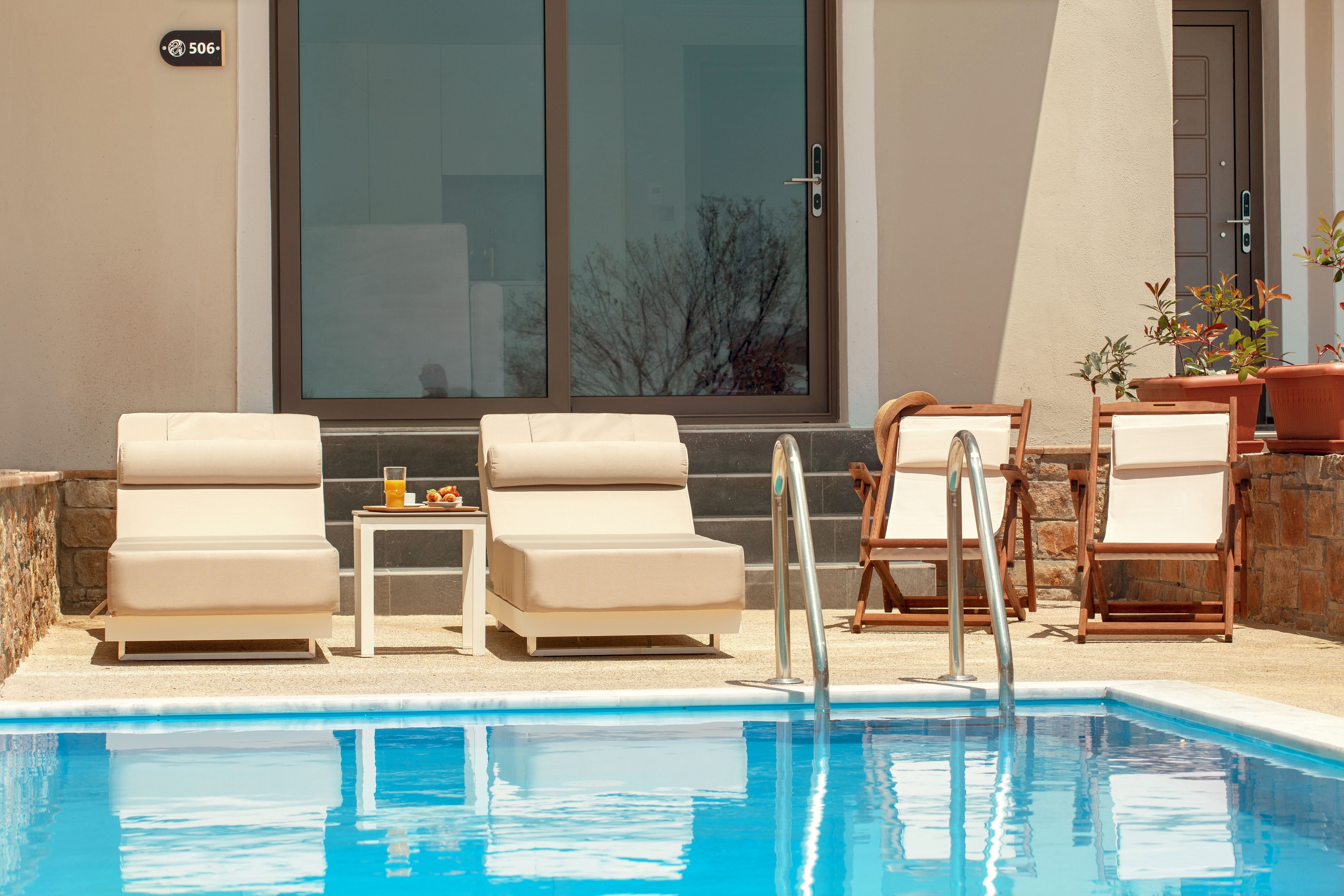 a pool with chairs and a table