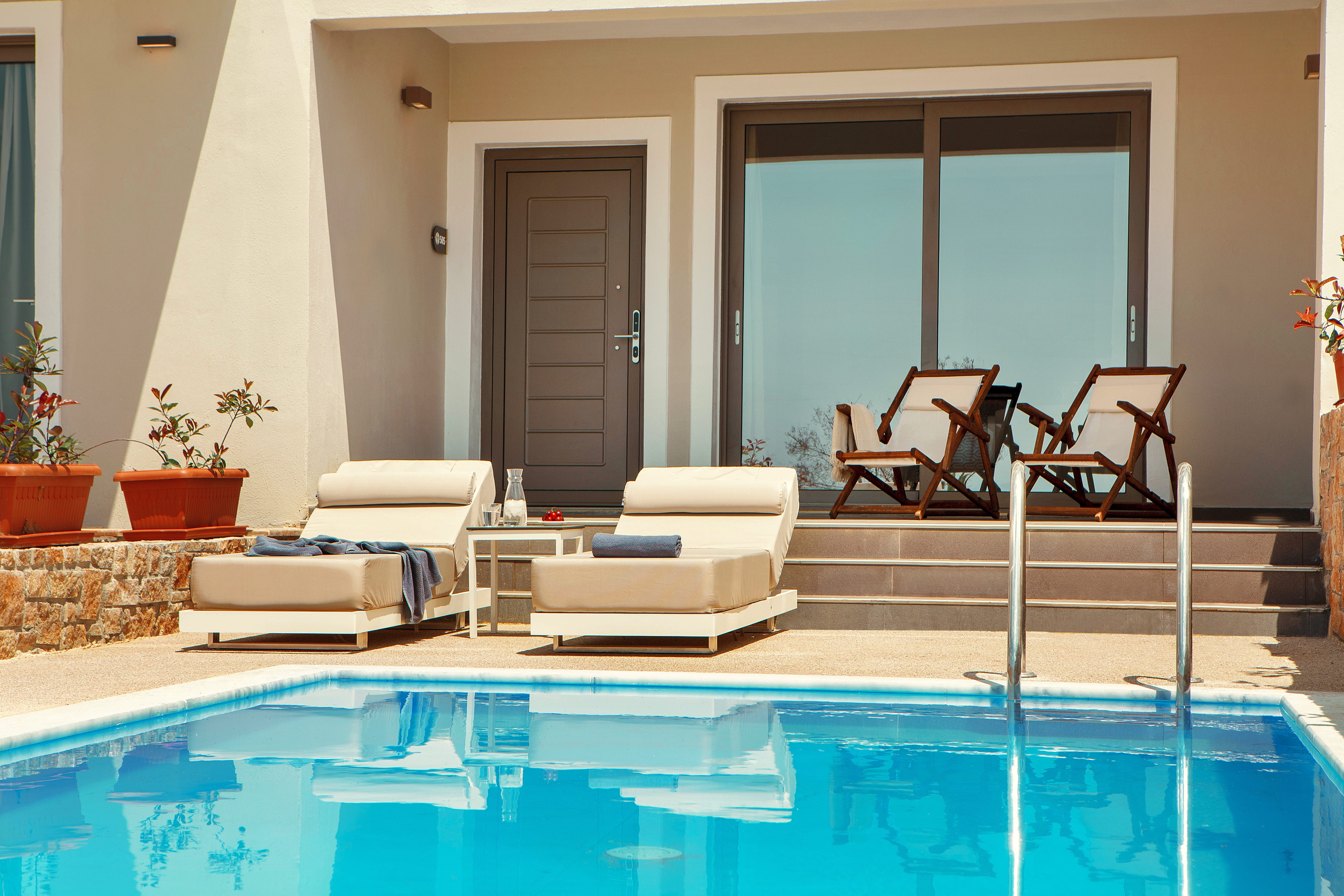 a pool with chairs and a deck chair