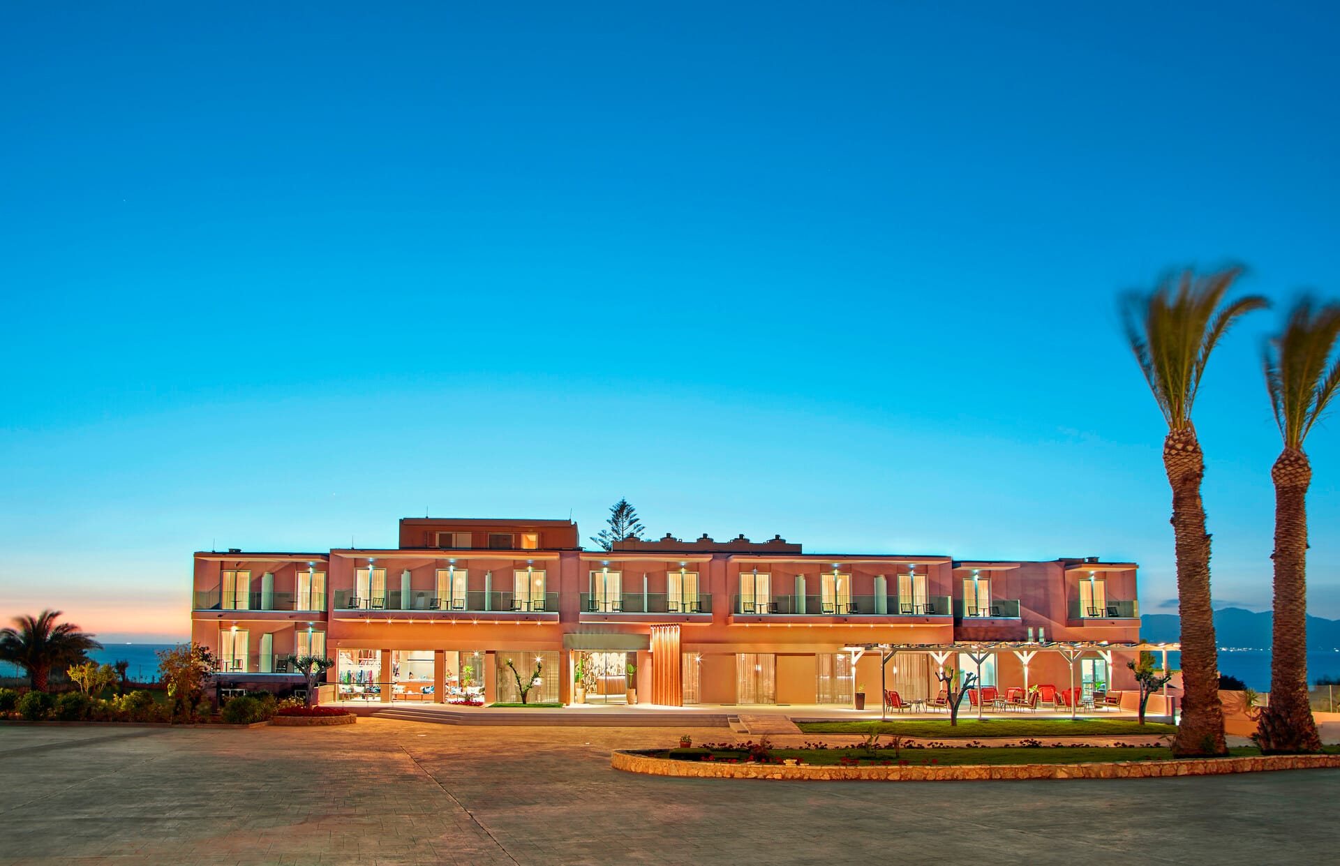 a building with palm trees in front