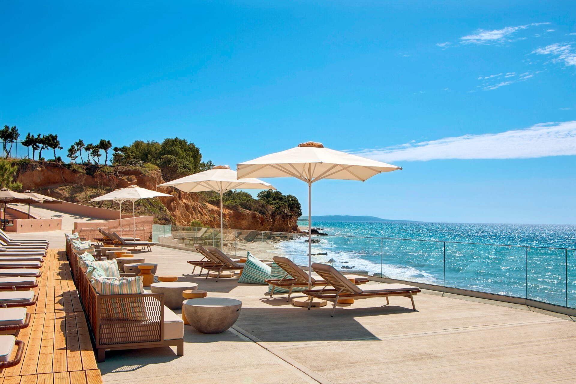 a beach with lounge chairs and umbrellas
