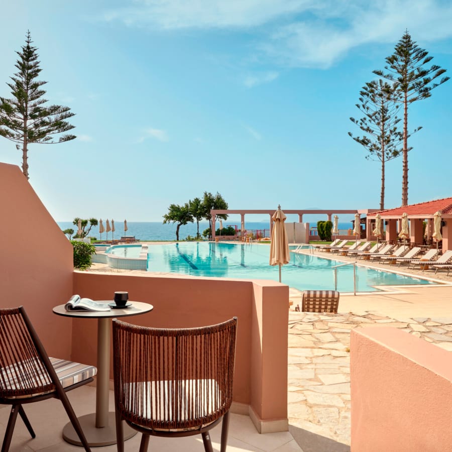a pool with chairs and a table