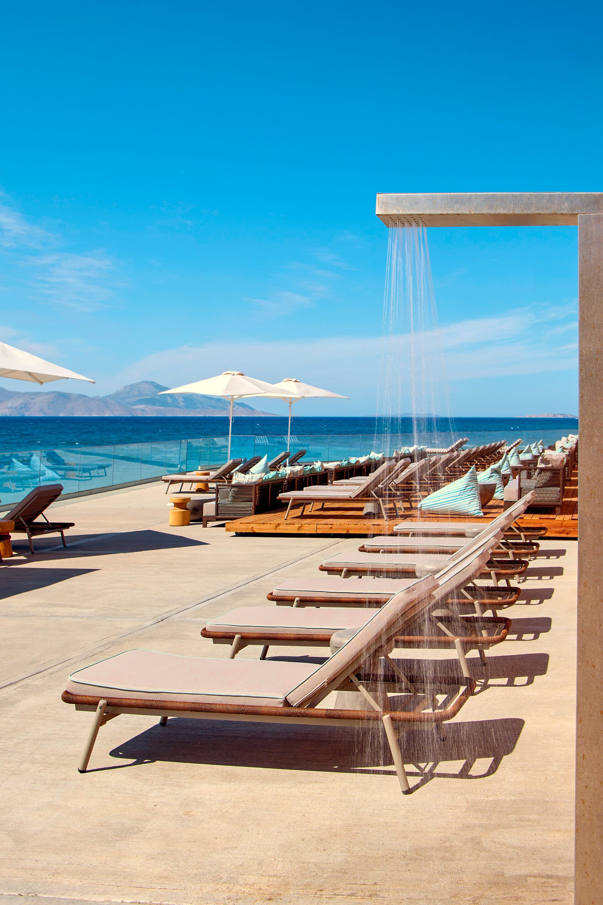 a group of wood benches on a beach