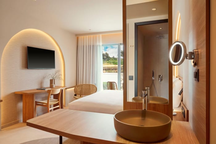 a bathroom with a large bathtub and a large mirror