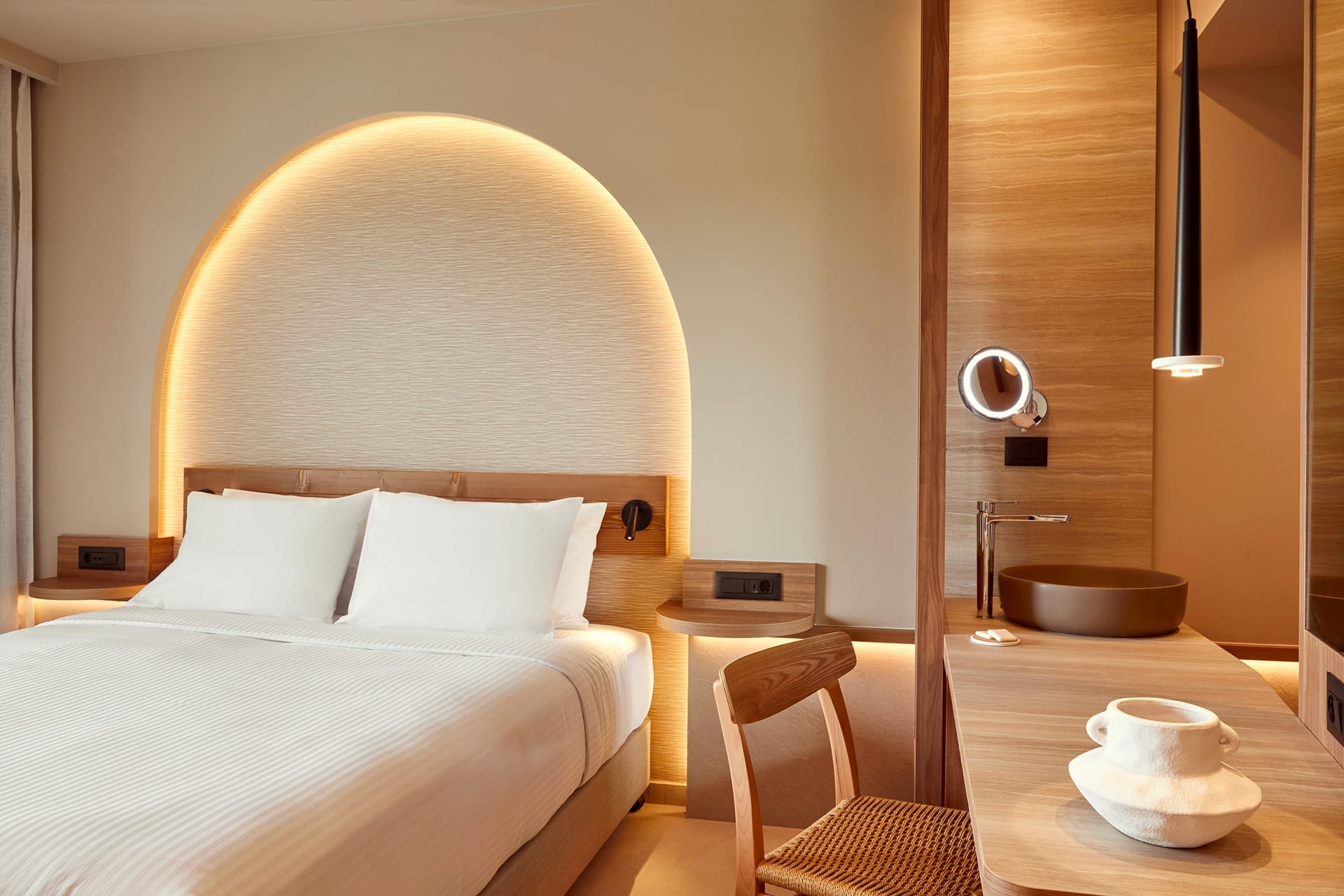 a bed with a round white pillow