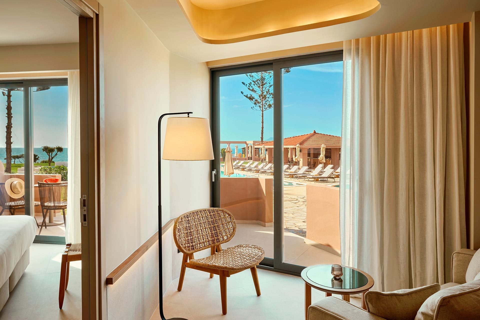 a room with a view of the ocean and a balcony