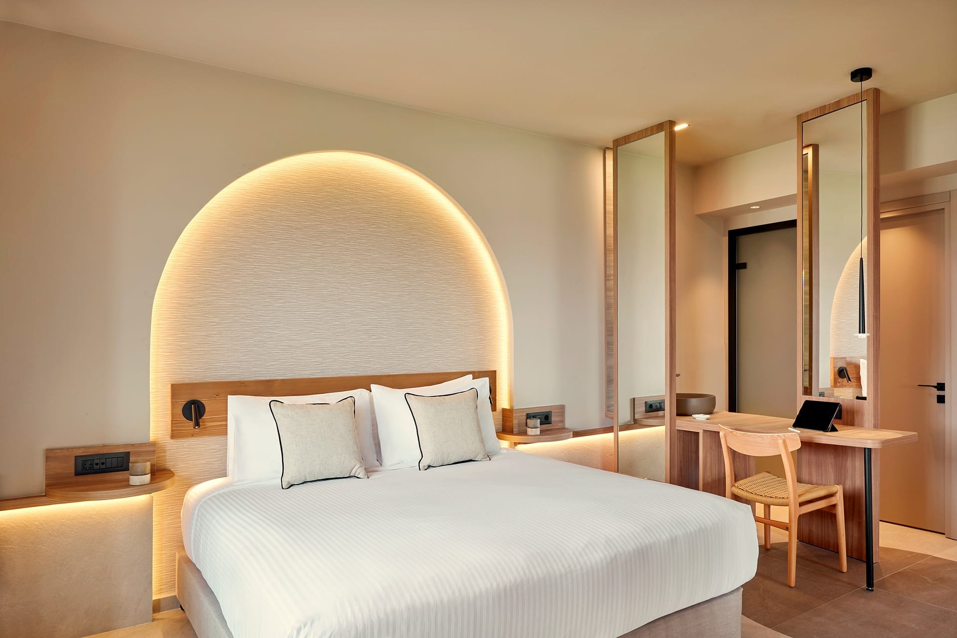 a hotel room with a bed and desk