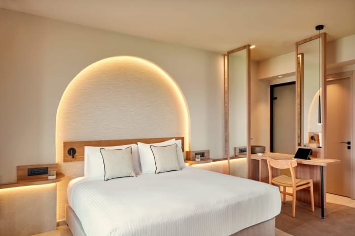 a hotel room with a bed and desk