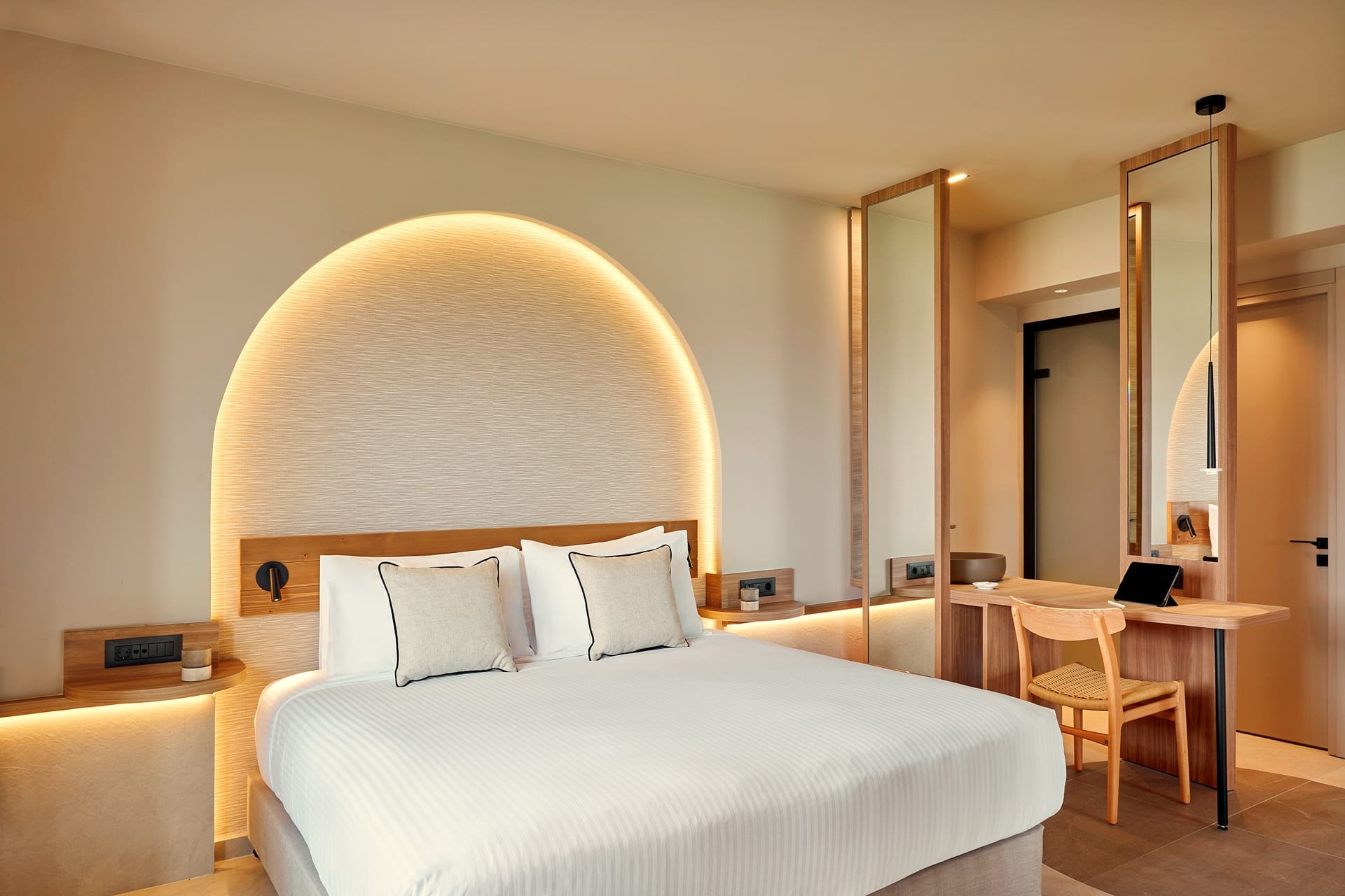 a hotel room with a bed and desk