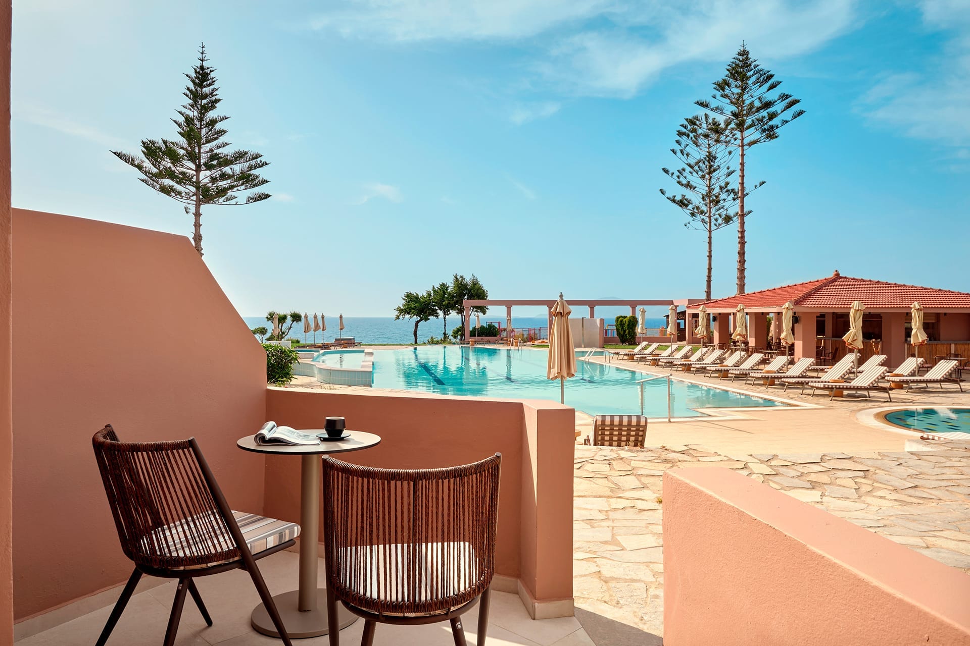 a pool and chairs by a deck