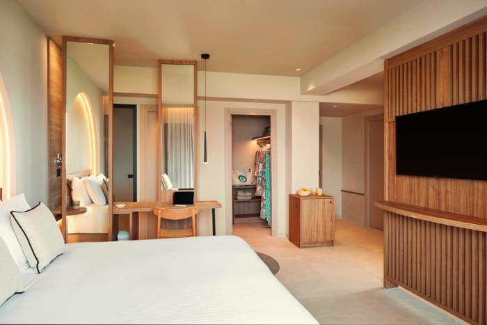 a bedroom with a large mirror