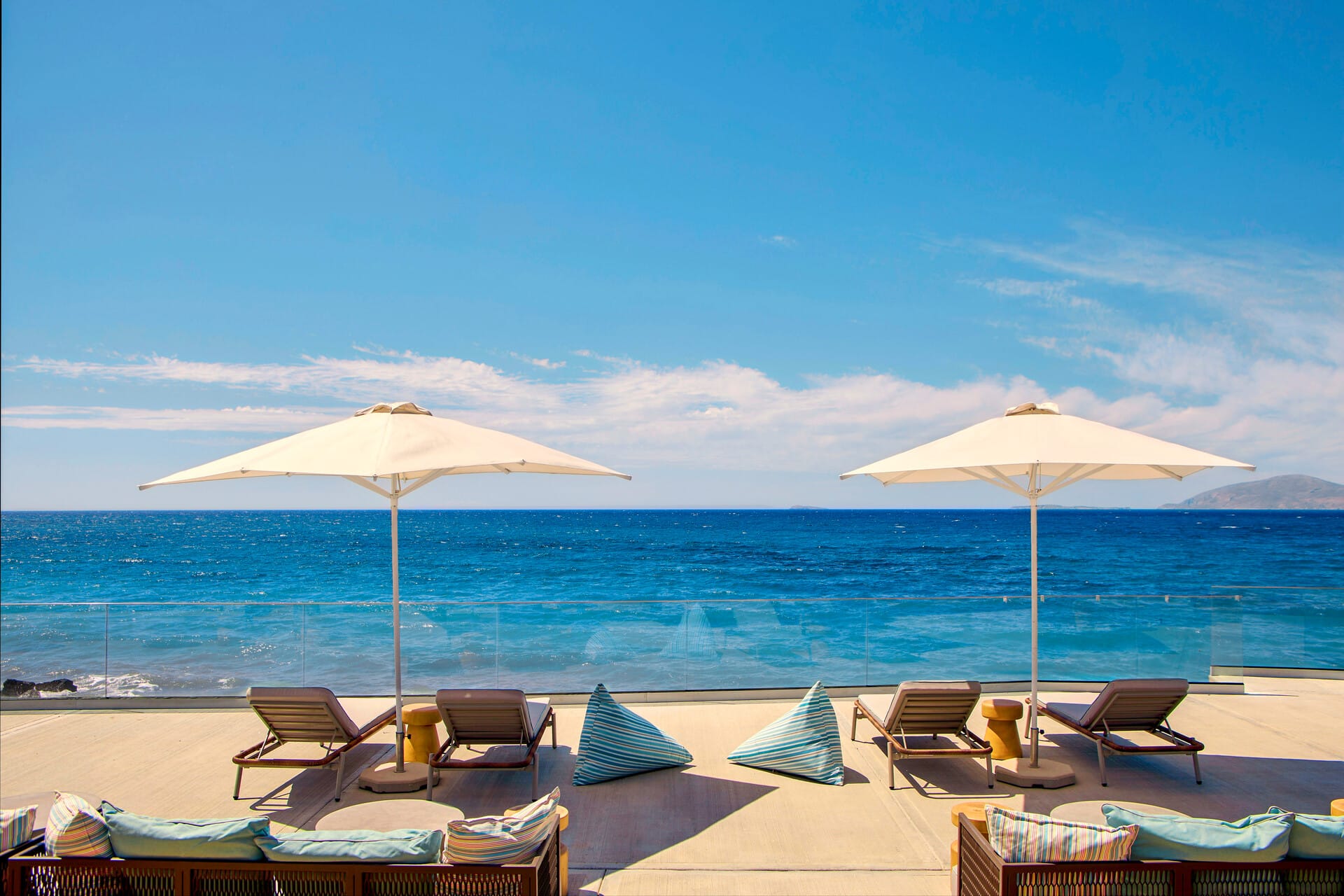 a beach with umbrellas and chairs