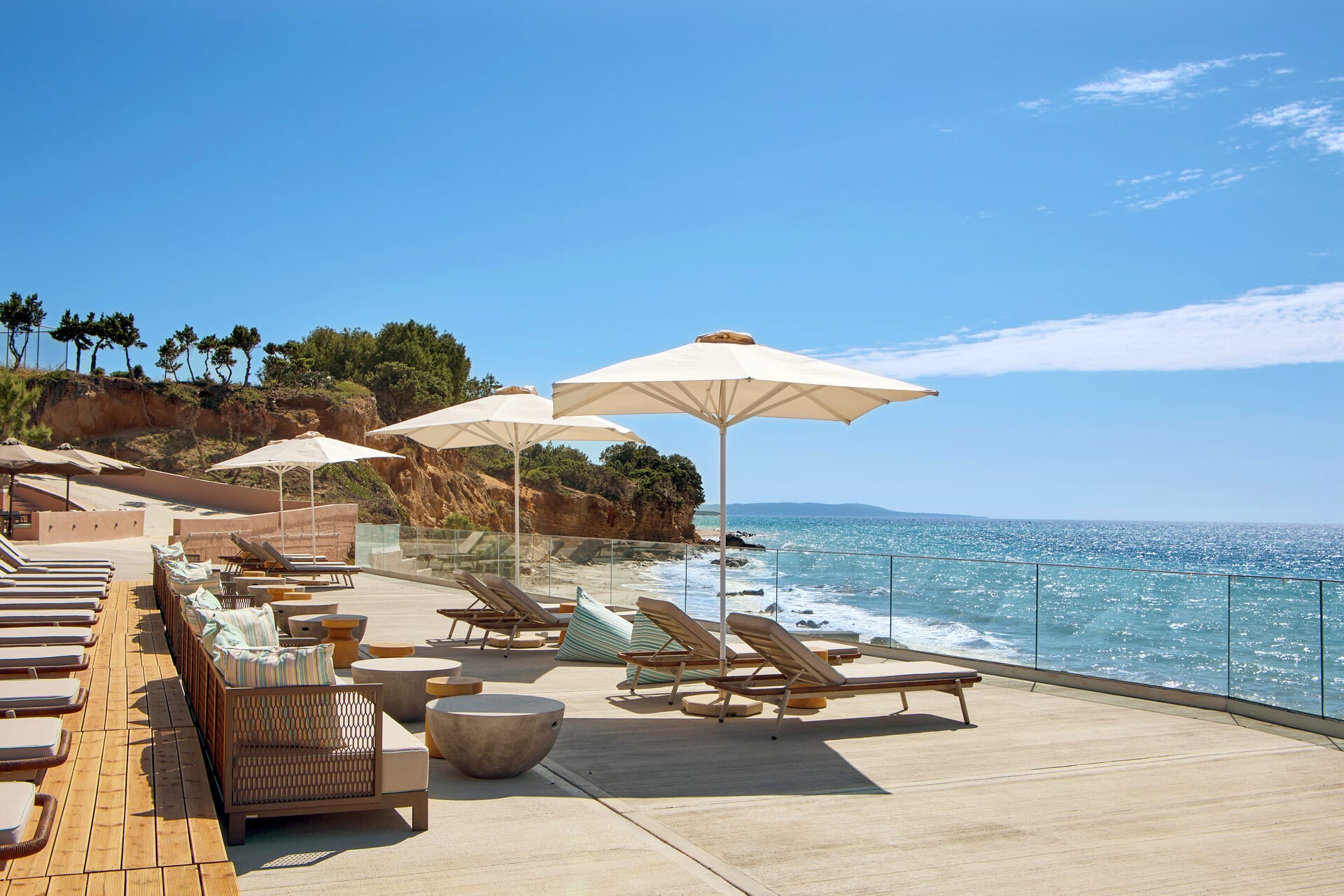a beach with lounge chairs and umbrellas