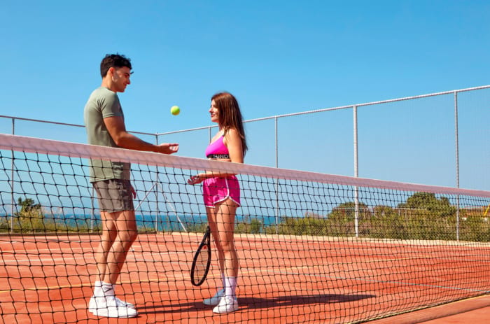 a man and a woman playing tennis