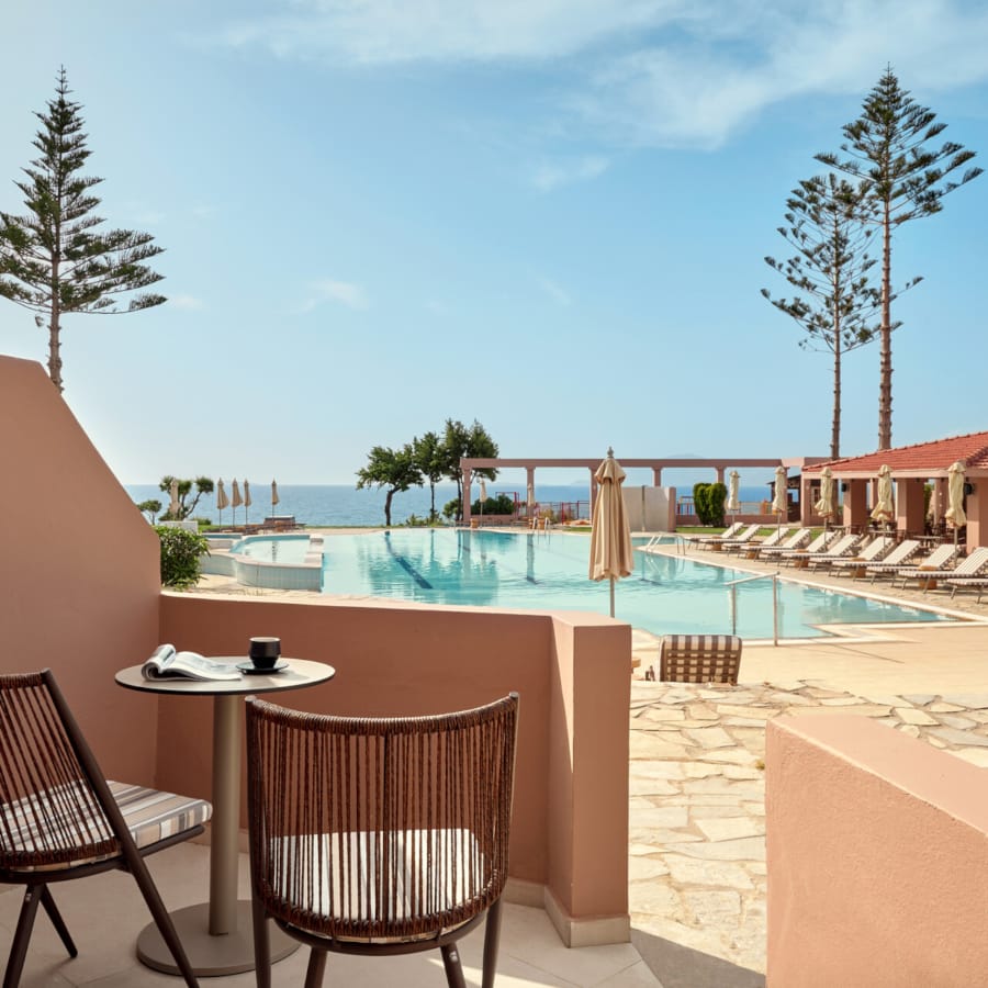 a pool with chairs and a table