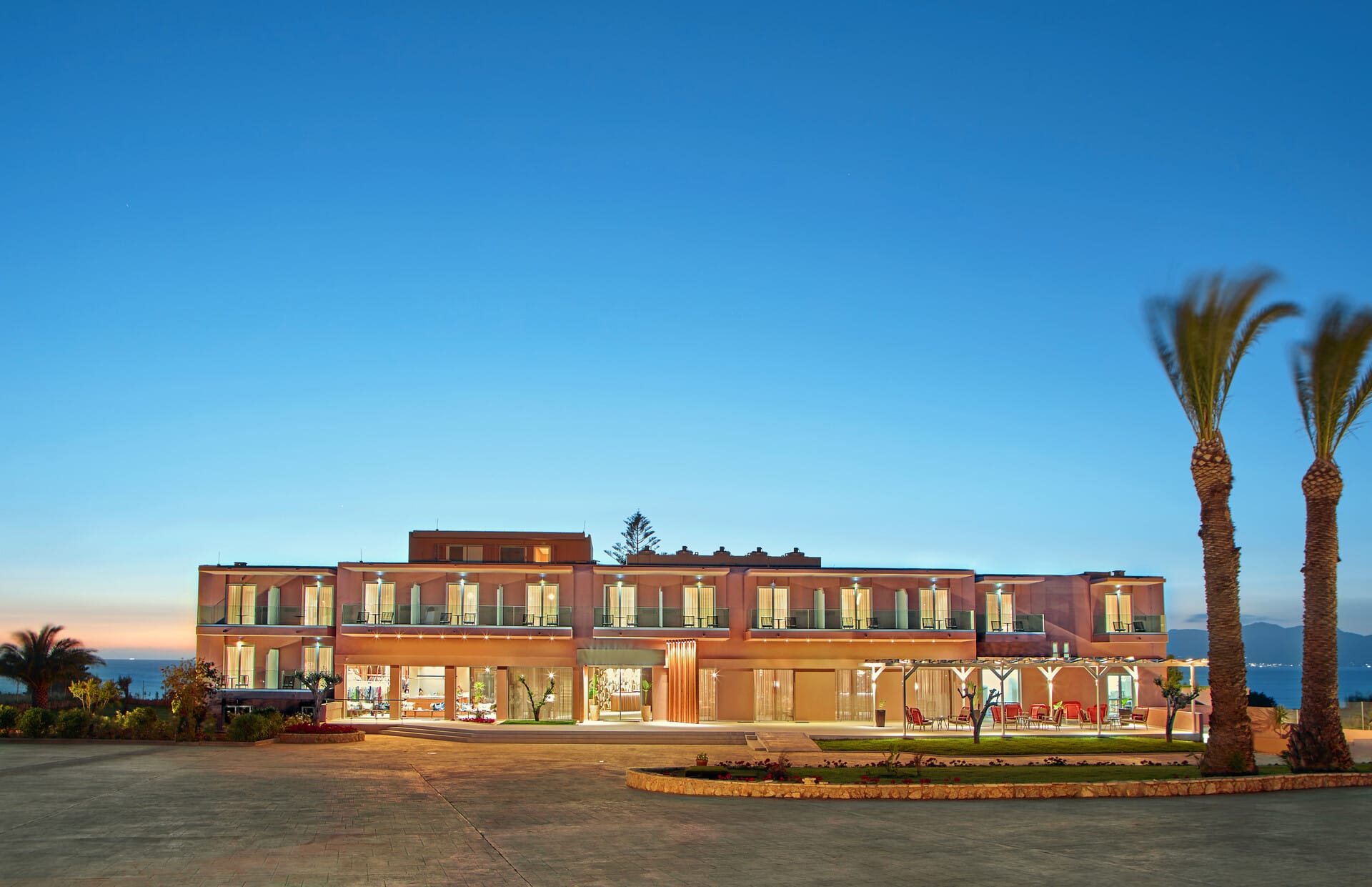 a building with palm trees in front