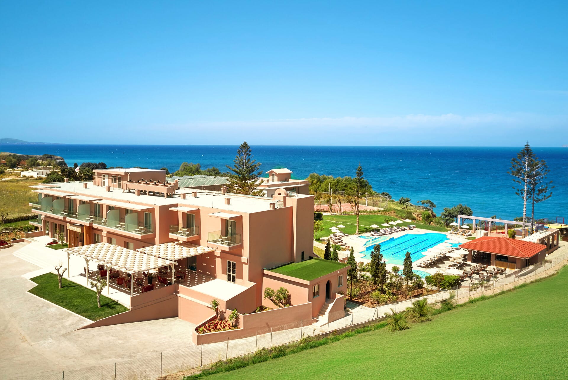 a building with a pool and a ferris wheel in the background