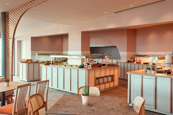 a kitchen with a bar and chairs