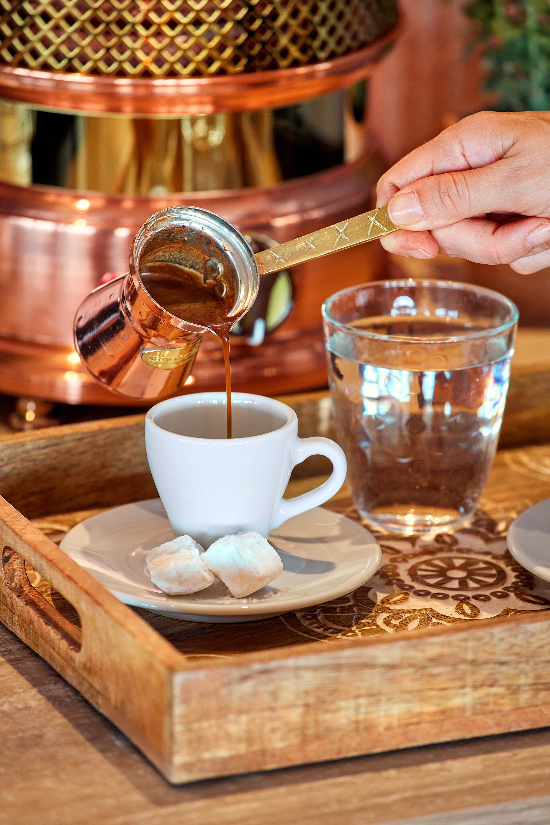 a person pouring a drink into a glass
