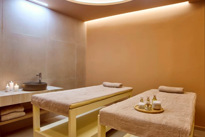 a bathroom with a bed and a sink