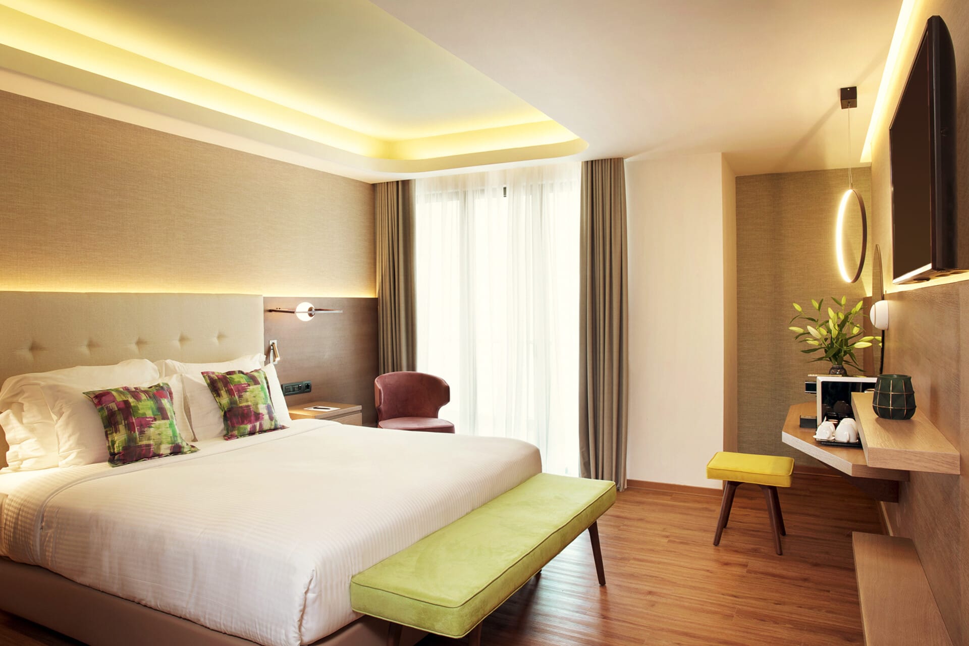 a hotel room with a bed and a bench