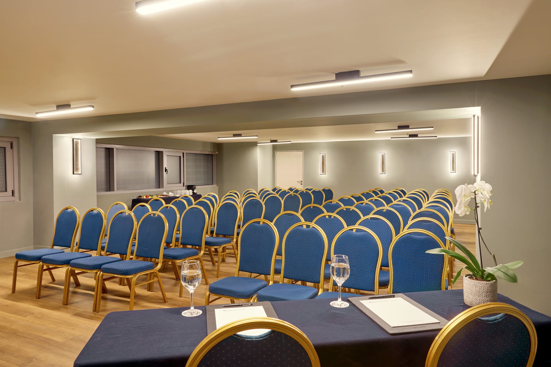 a room with blue chairs and tables