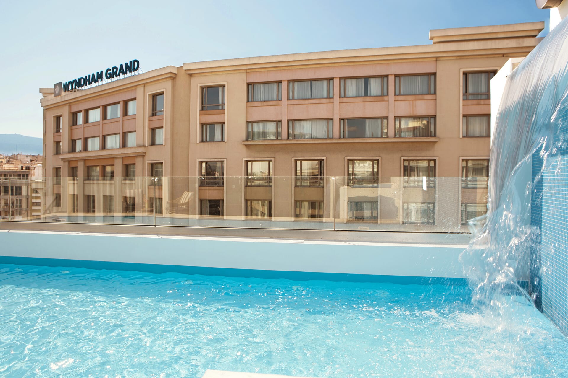 a large building with a pool in front of it