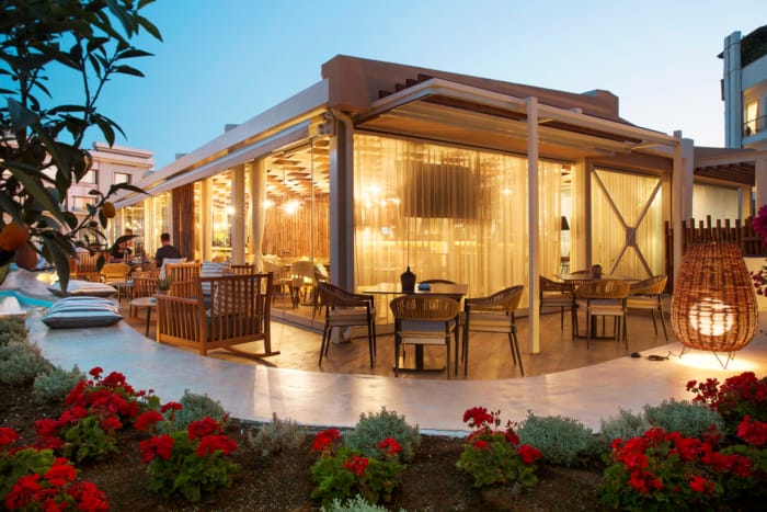 a house with a pool and chairs