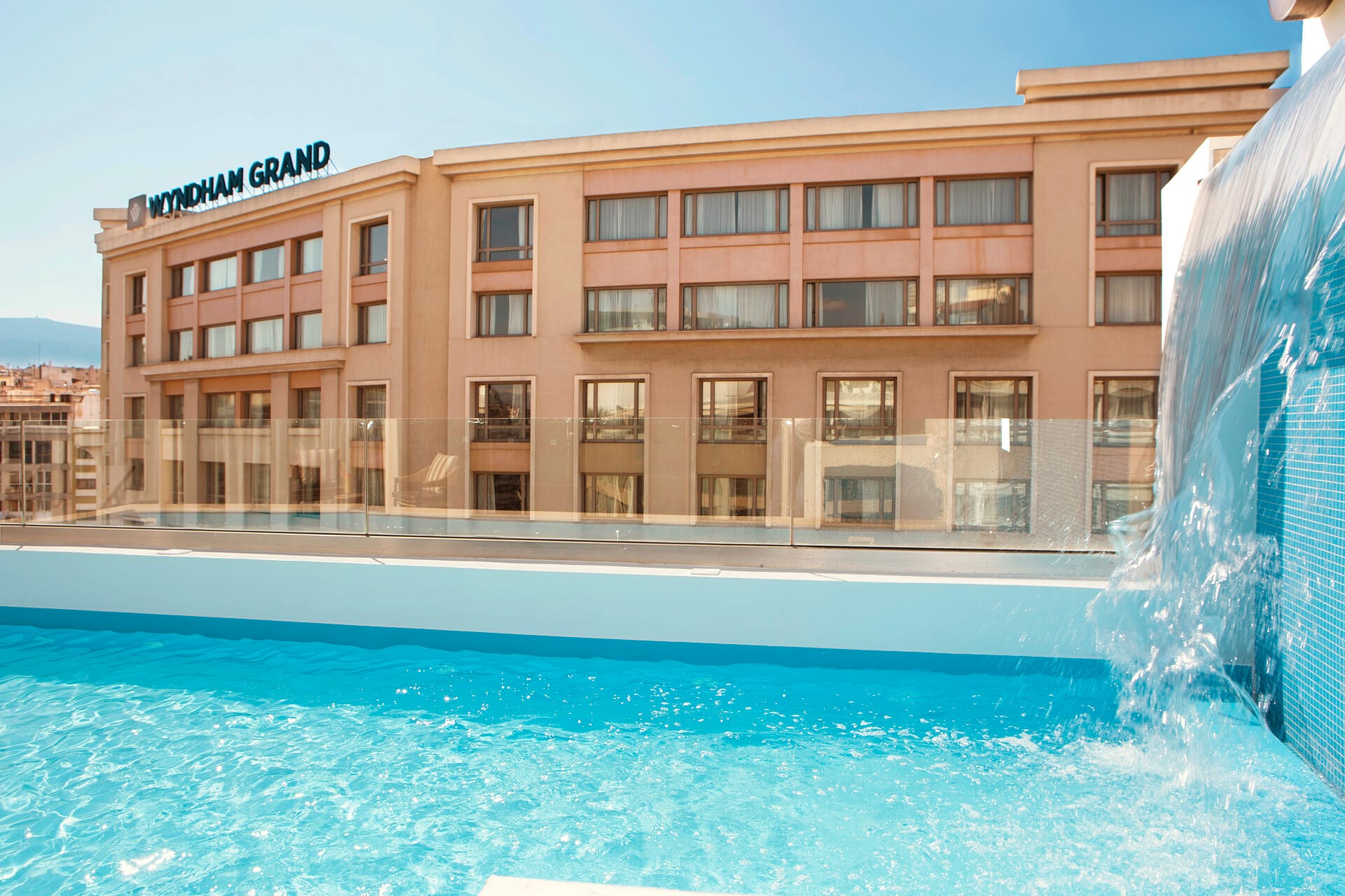 a large building with a pool in front of it