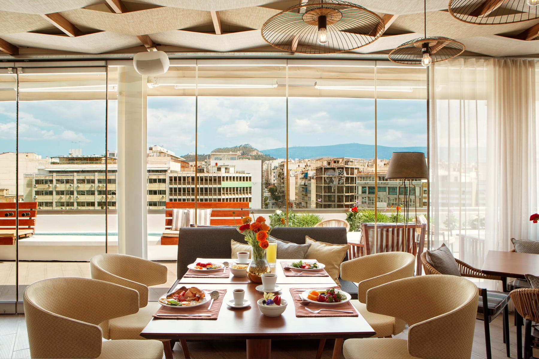 a room with tables and chairs with food on them