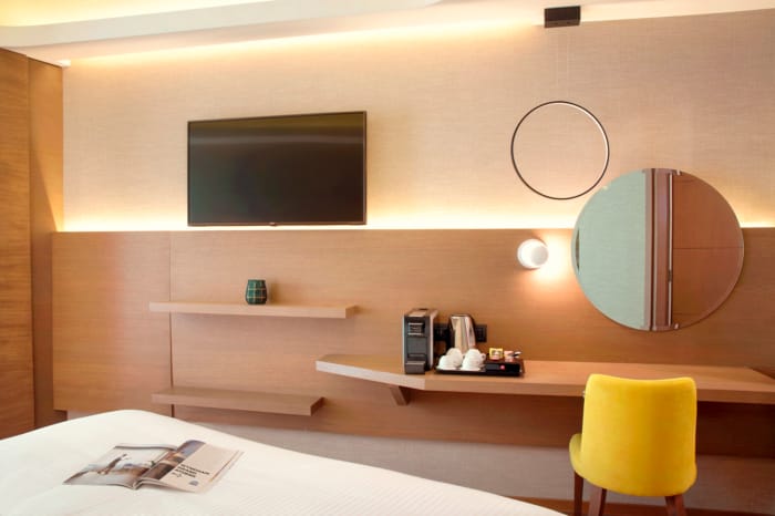 a room with a desk and a television