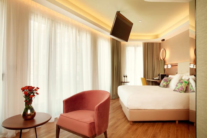 a bedroom with a bed and a chair