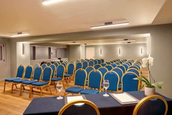 a room with blue chairs and tables