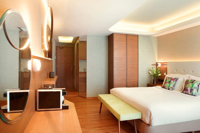 a bedroom with a bed and a television