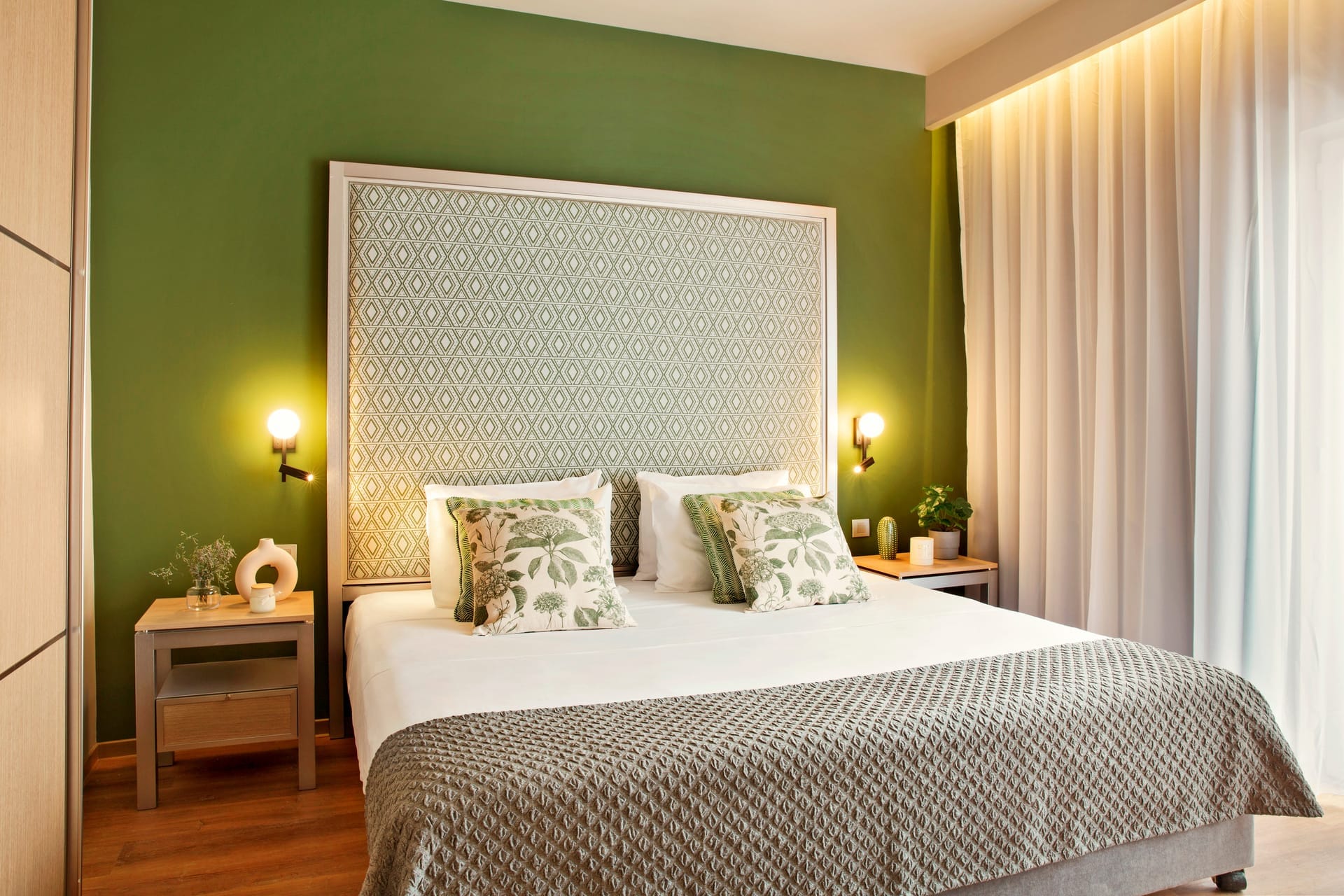 a bed with a green wall