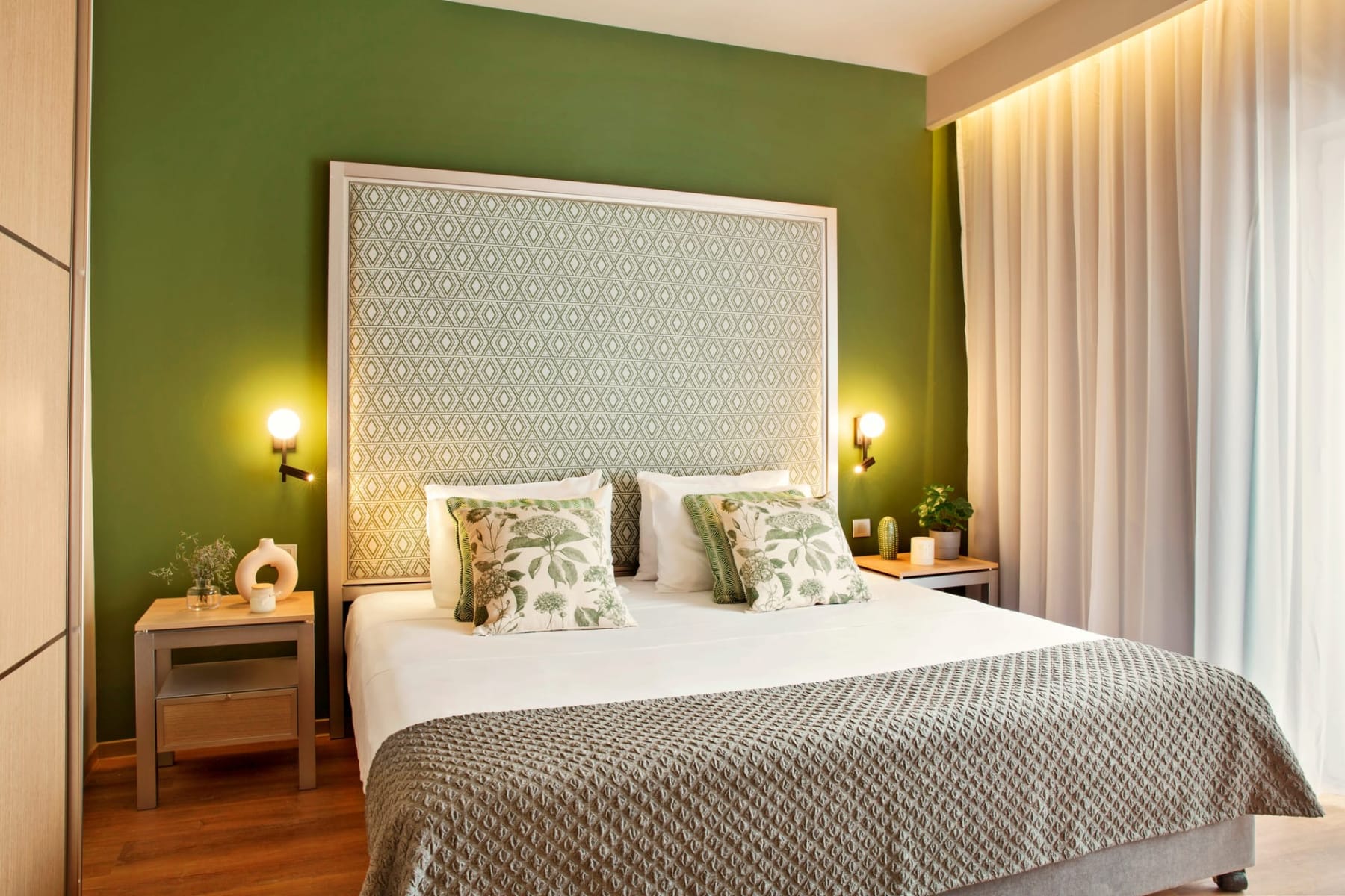 a bed with a green wall