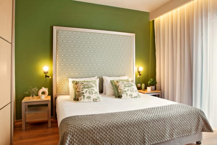a bed with a green wall