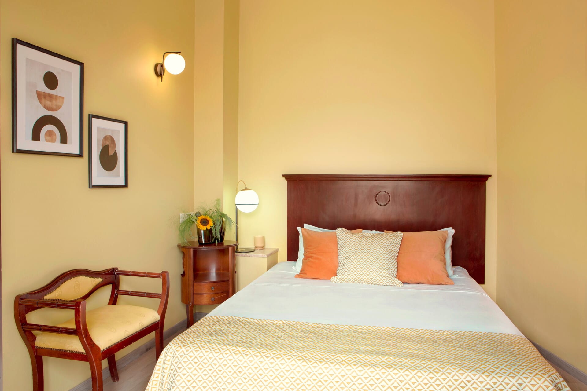 a bed with a chair and a table in a room