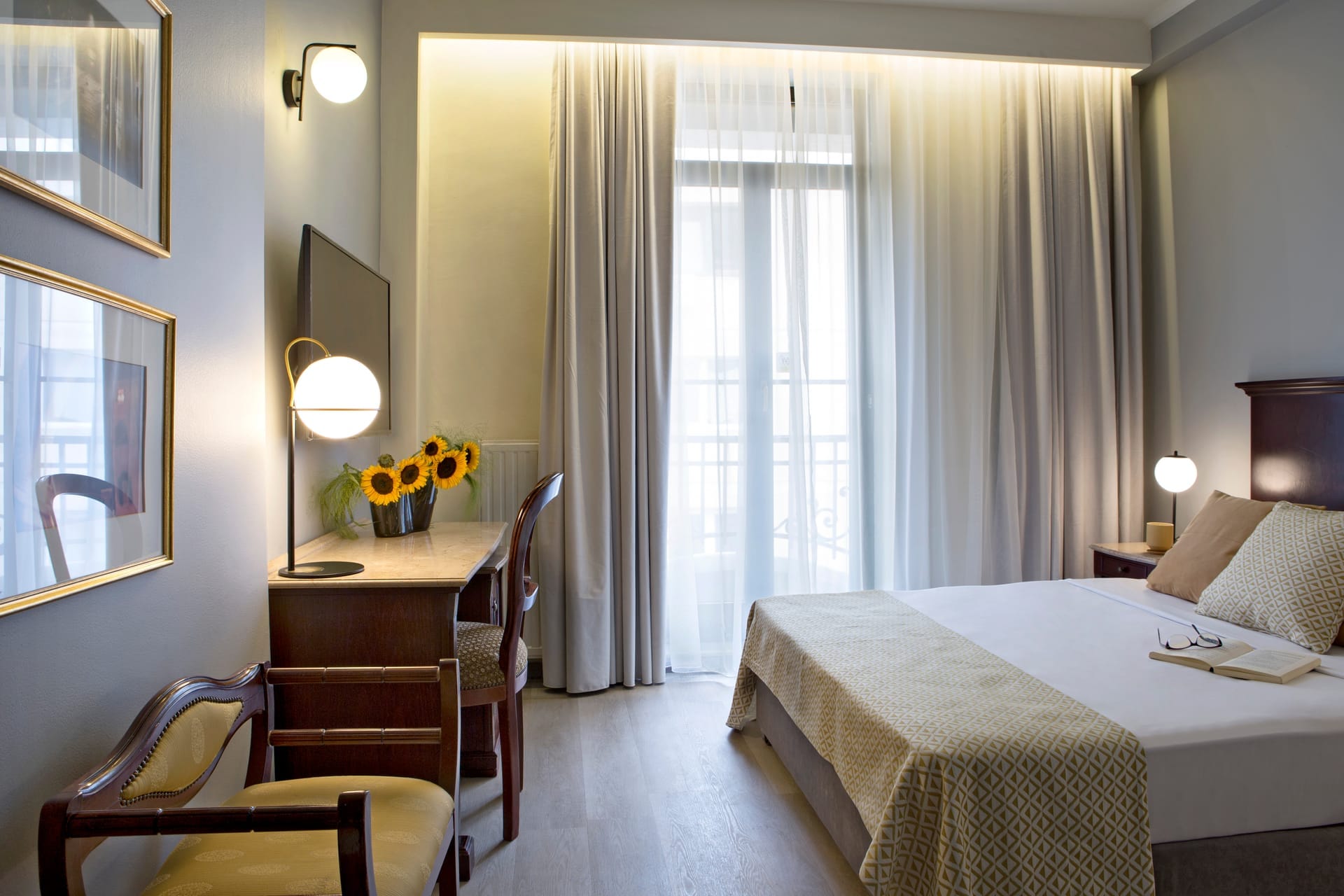 a bedroom with a bed desk and a mirror