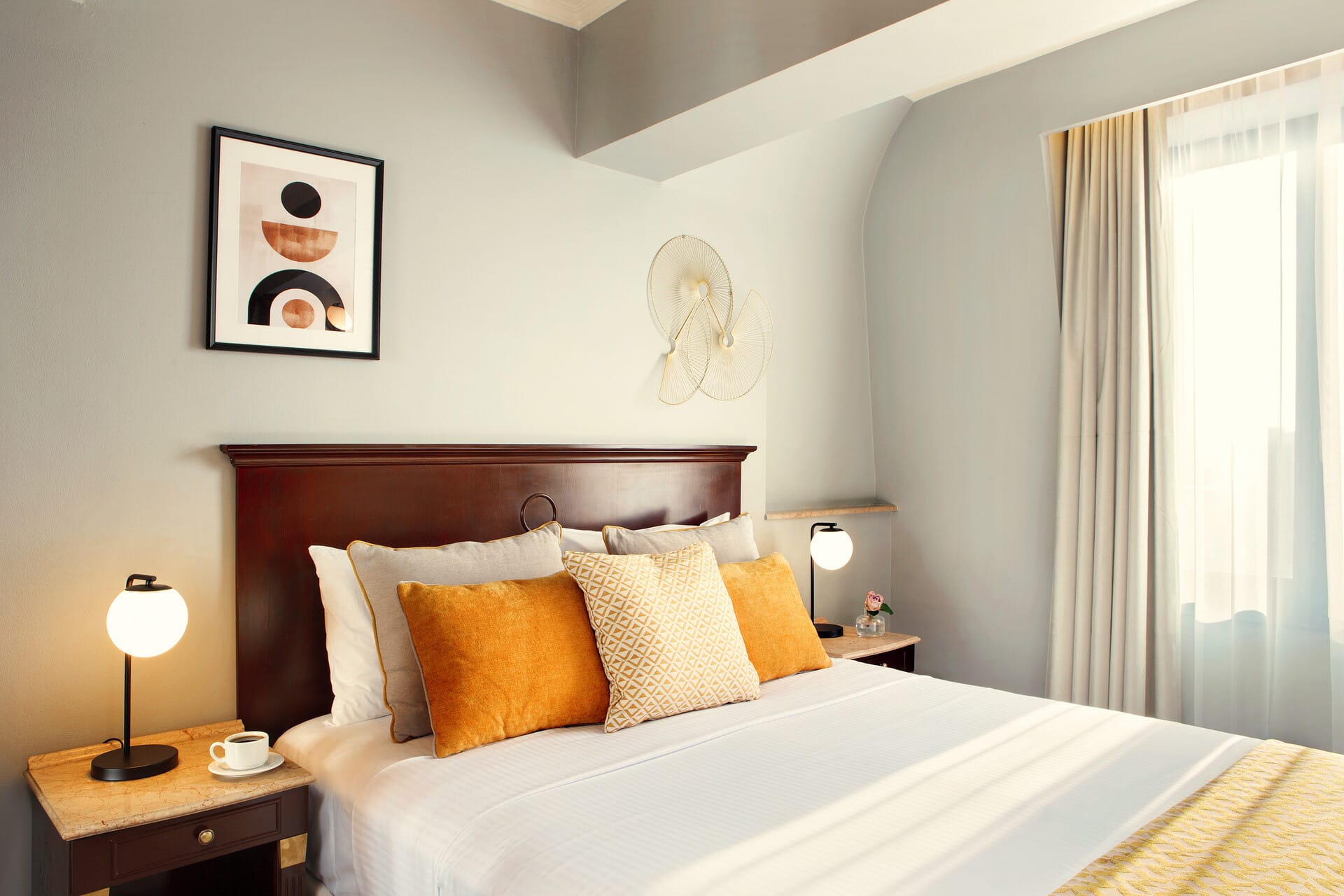 a bed with orange pillows