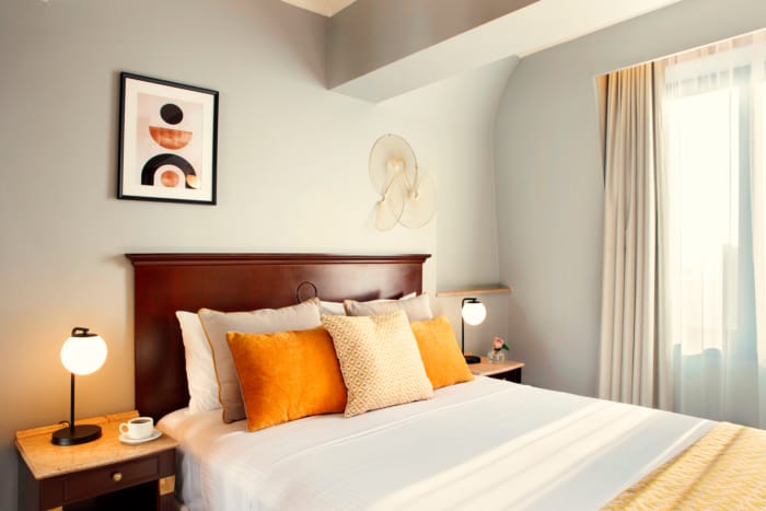 a bed with orange pillows