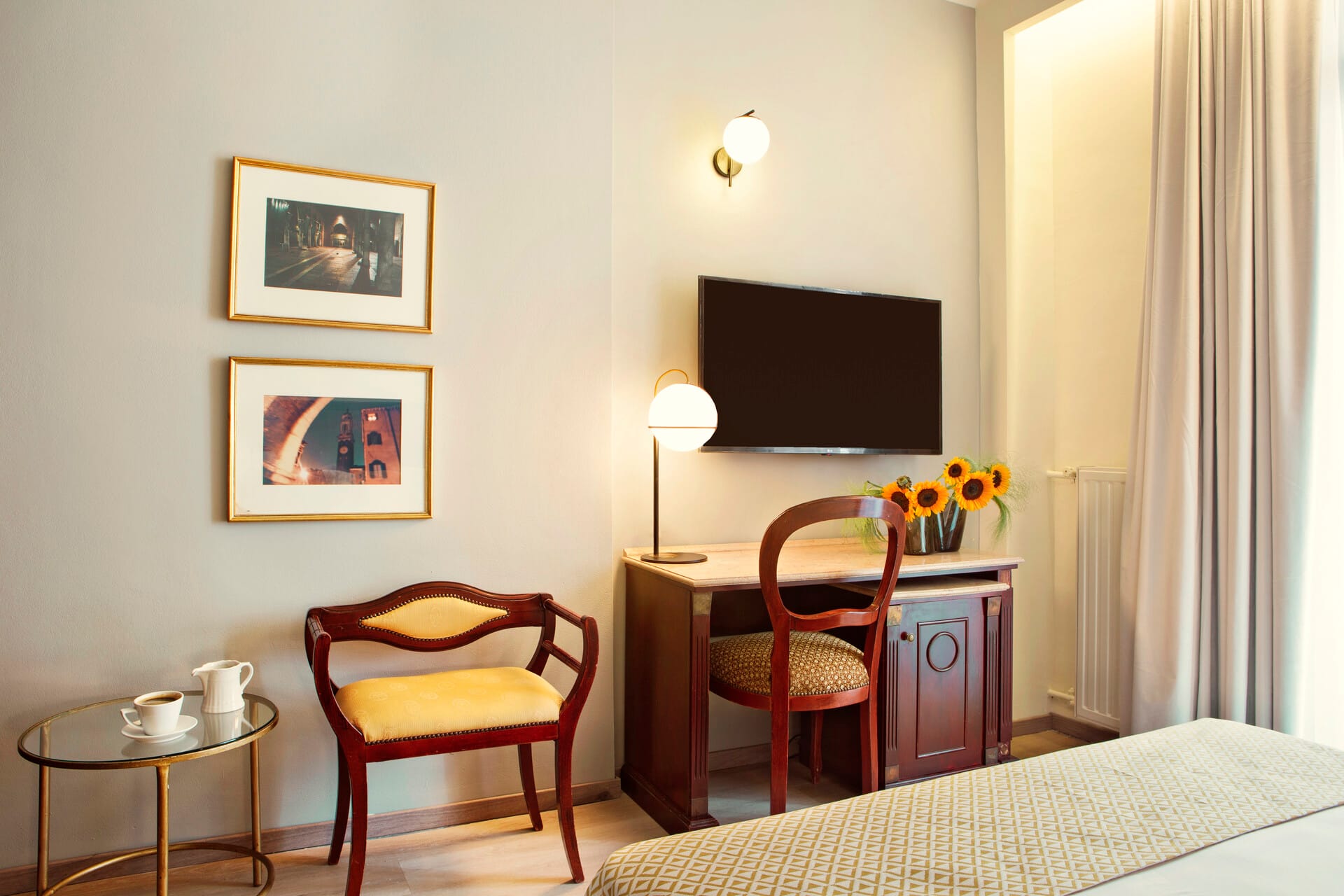 a bedroom with a tv and chairs