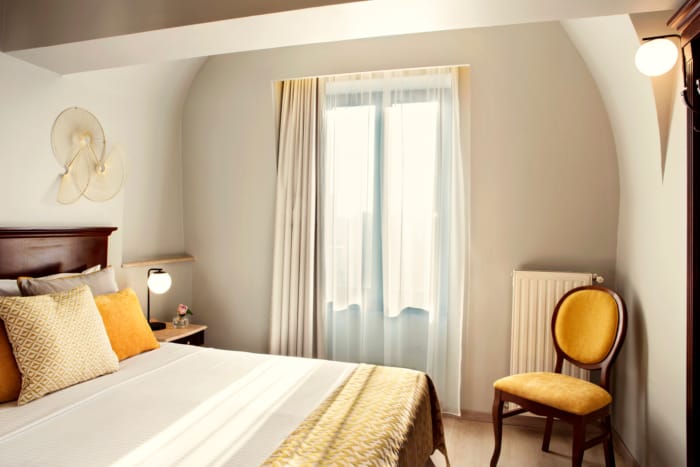 a bedroom with a bed and a chair