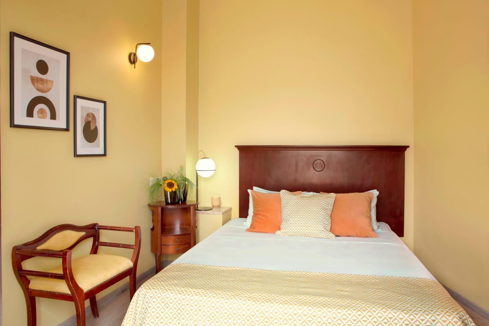 a bed with a chair and a table in a room