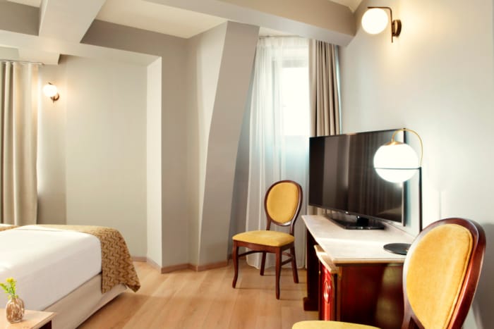 a bedroom with a bed and a desk