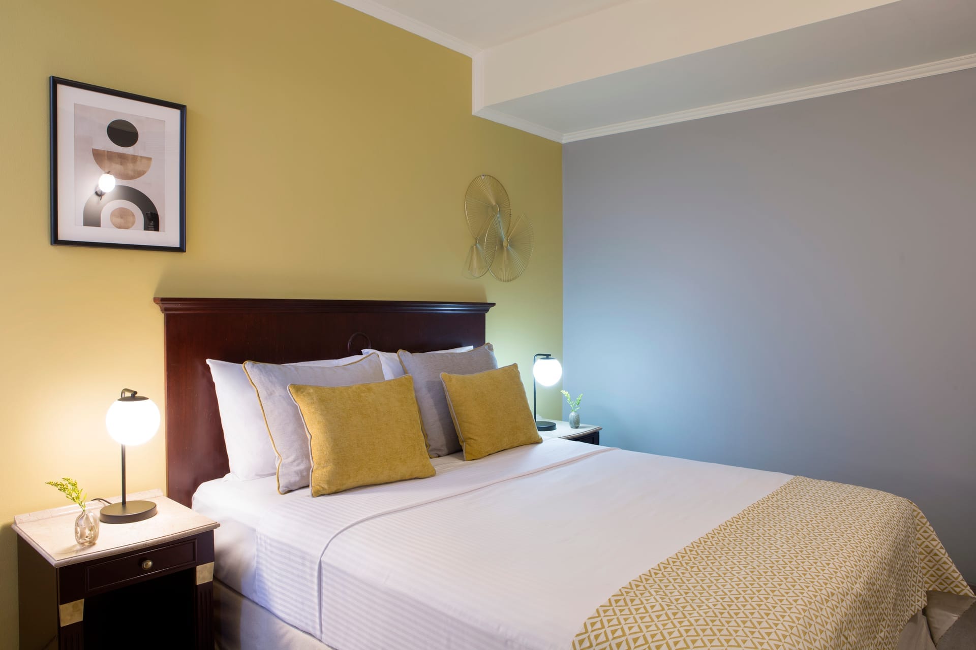 a hotel room with a bed and lamps